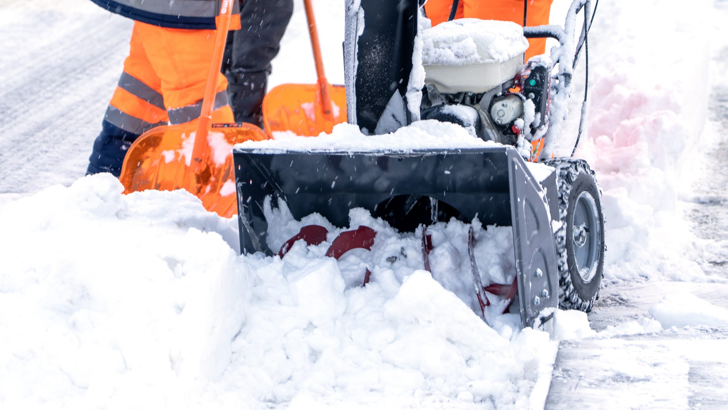 Snowplow clears thick snow from street path