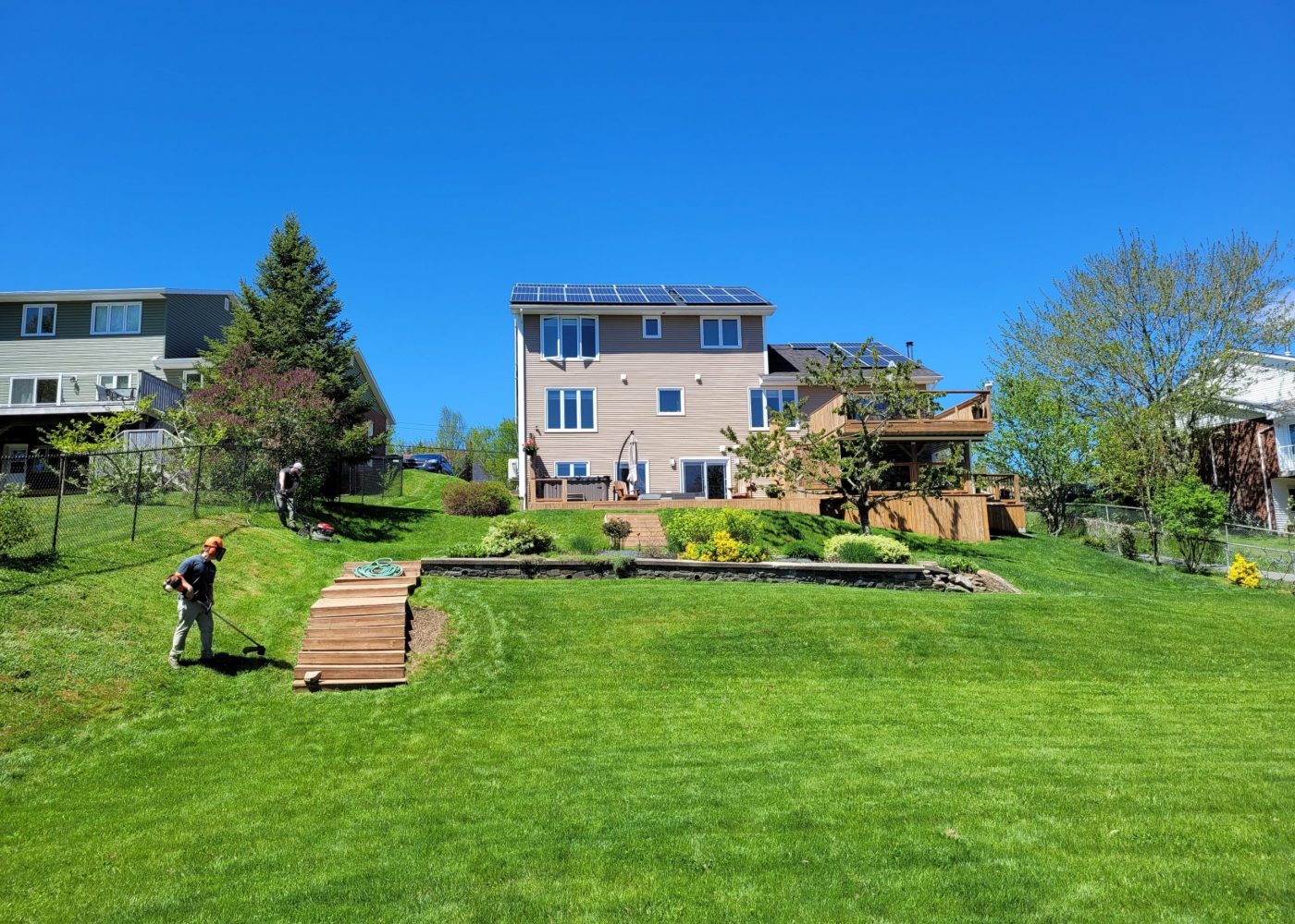 man working on lawn maintenance in a back yard